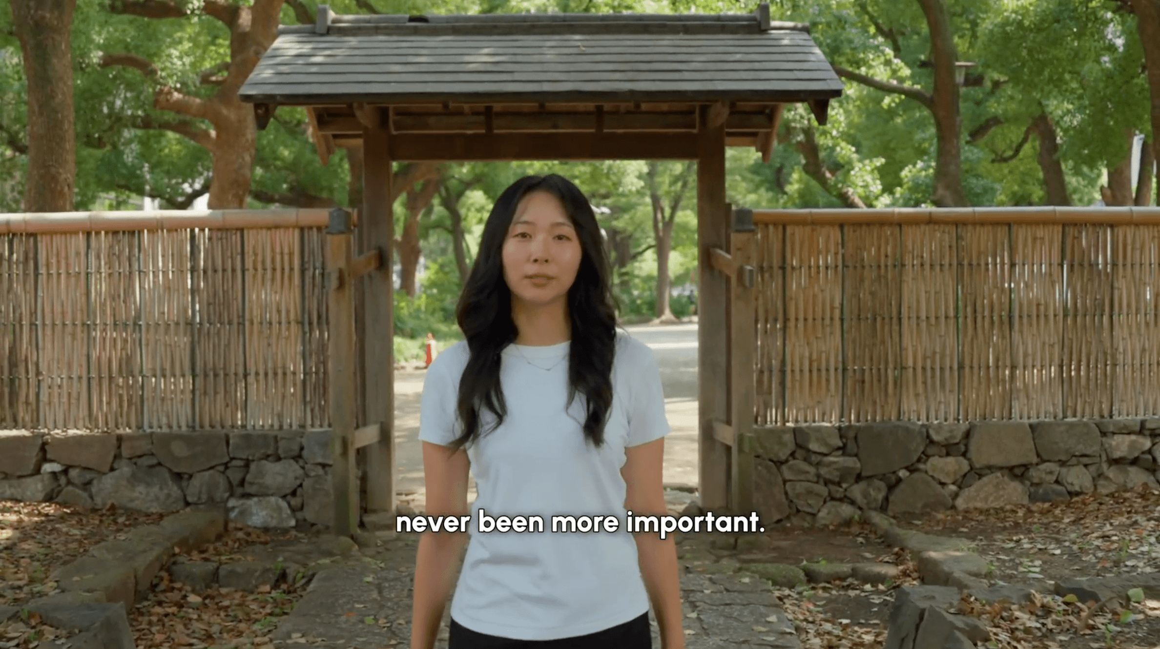 A TOMOGO! Local Expert introducing herself at a shrine gate