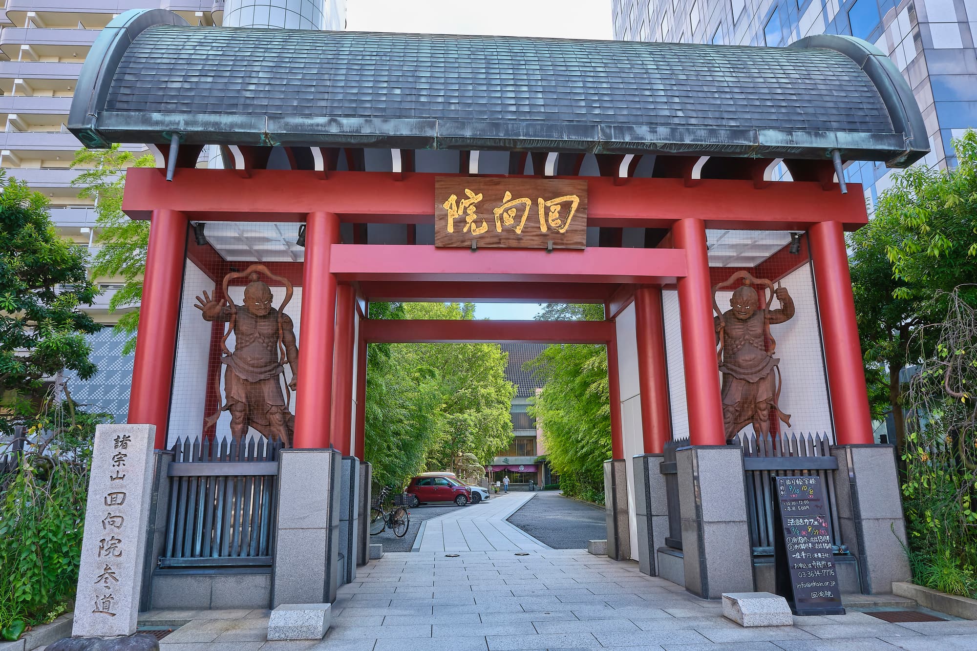 Red gate of Ekoin Temple in Tokyo, flanked by two carved wooden Nio guardian statues